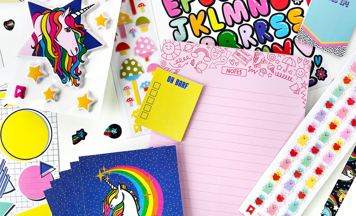 A Pipsticks Stationery Club flatlay of notepads, washi tape, sticker sheets and paper goods