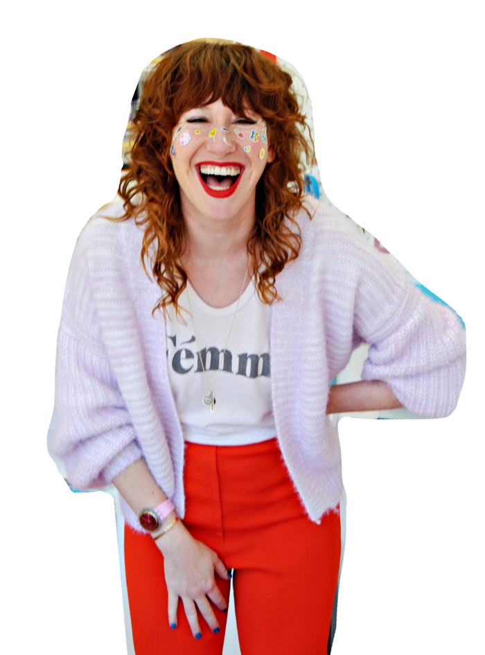 Mo Vazquez, founder of Pipsticks, laughing with stickers on her face